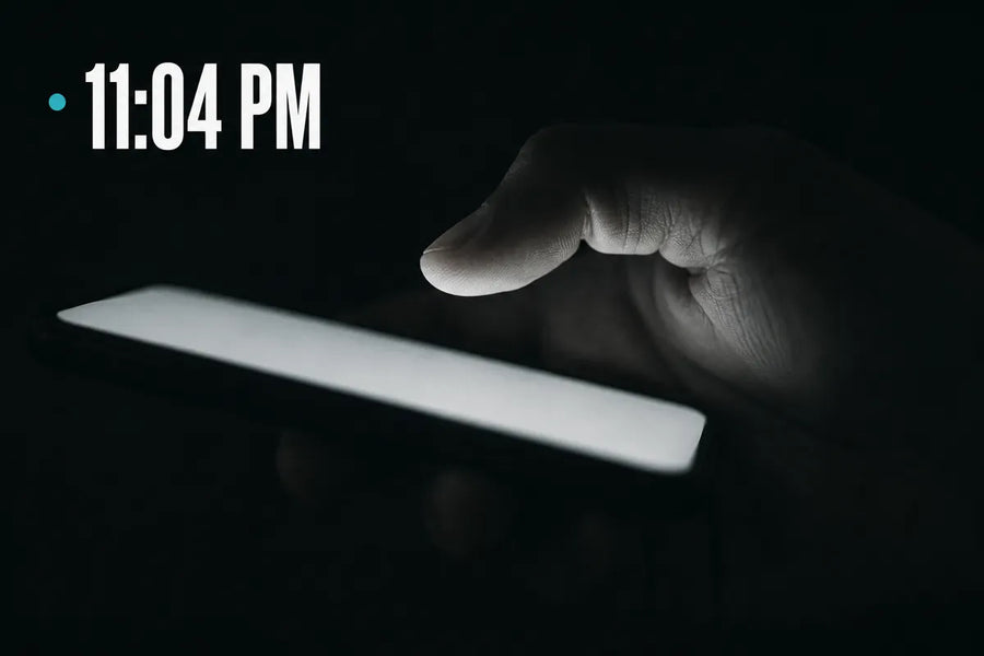 11:04 PM - a thumb hovering over a glowing phone screen in the dark, not yet touching send