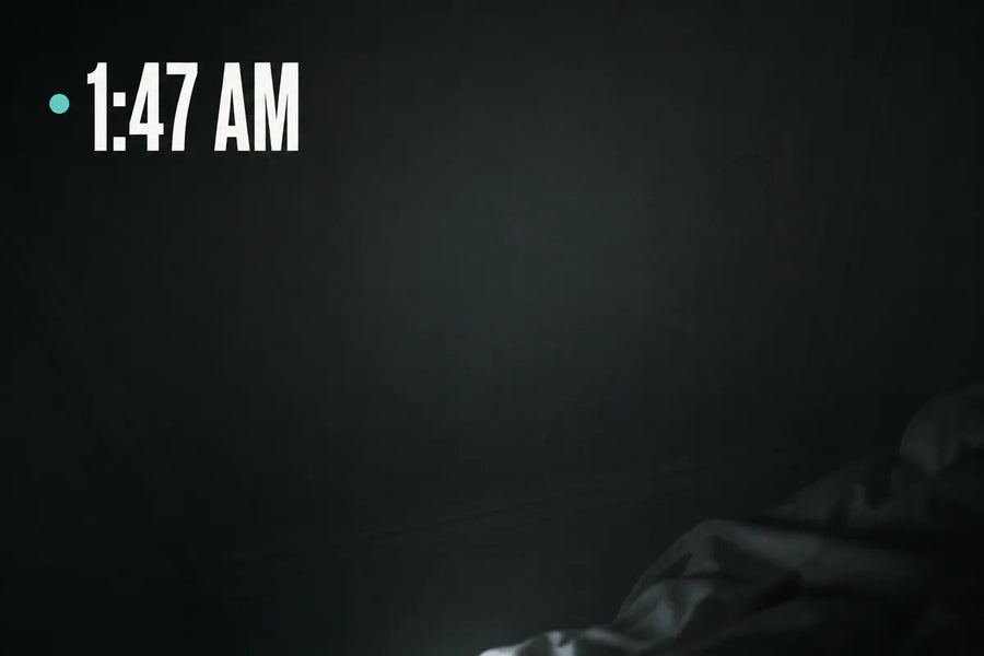 1:47 AM - a dark bedroom ceiling seen from the pillow, lit only by a phone glow